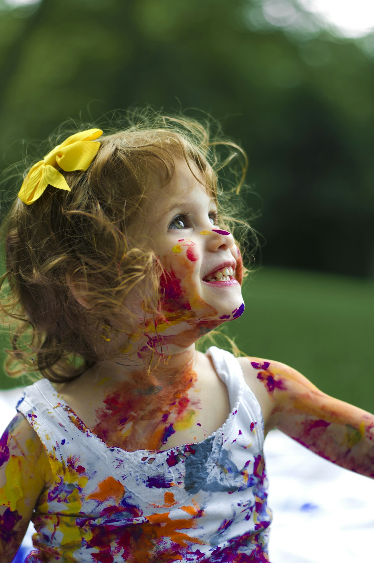 A young child laughing in soft daylight