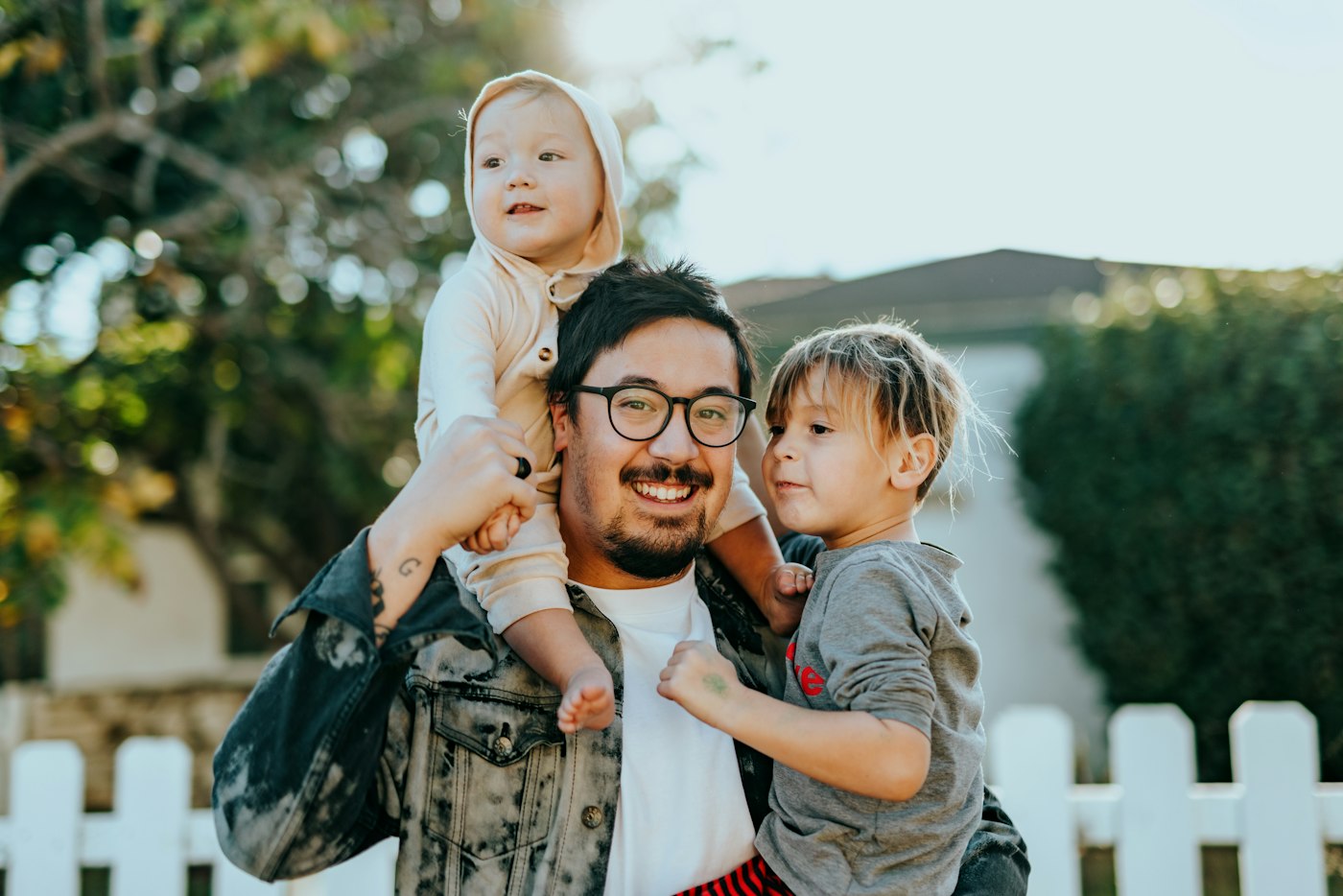 Parents and children smiling together outdoors